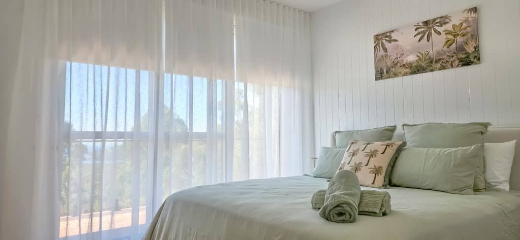 Sheer Curtains with Blockout Roller Blinds in a Bedroom